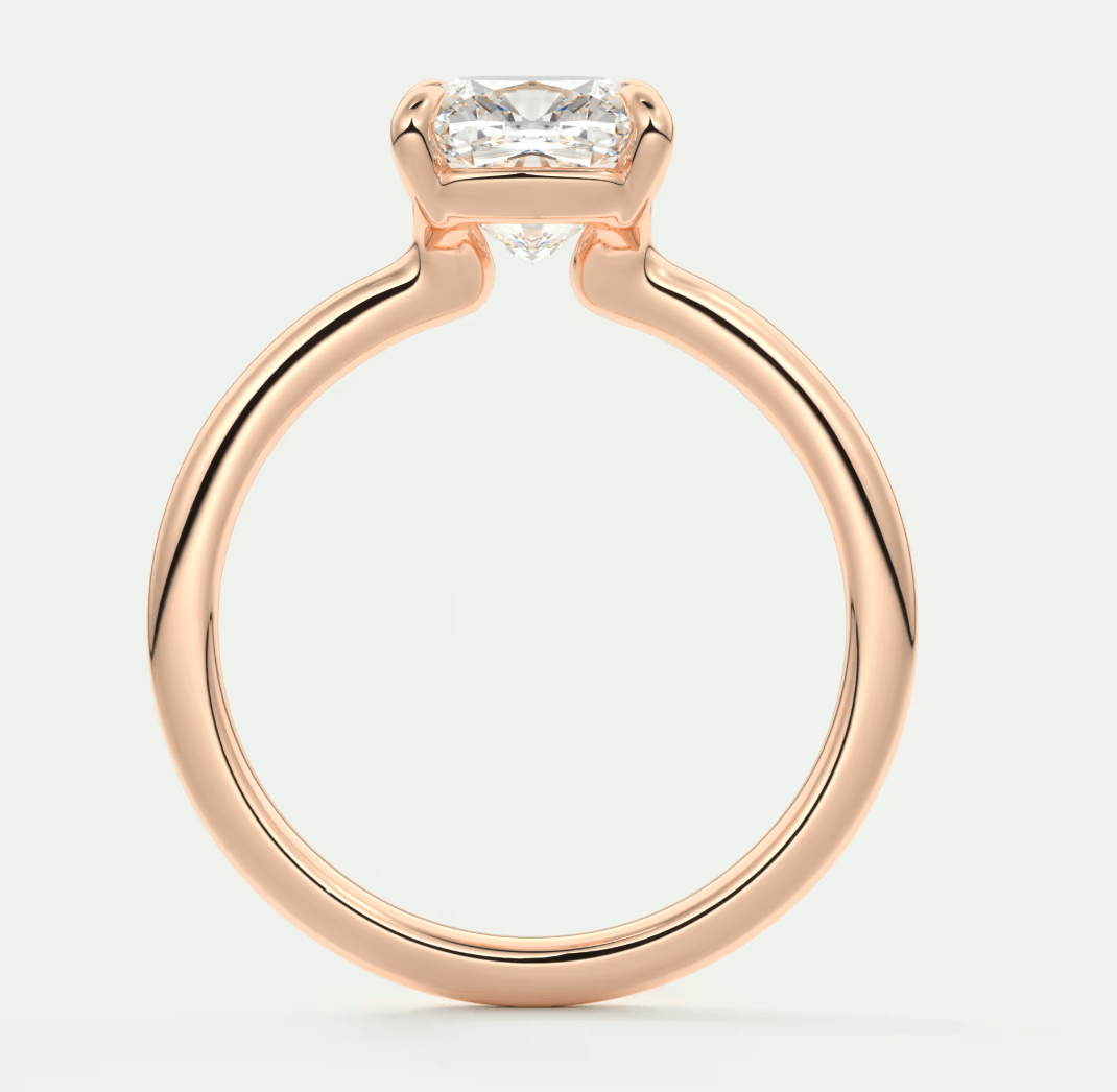Rose gold princess cut diamond engagement ring with a sleek, modern design.