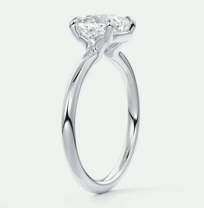 18k white gold solitaire diamond engagement ring with a cushion-cut center stone.