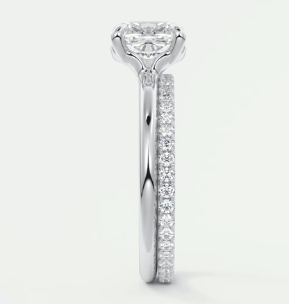 18k white gold diamond engagement ring with a round brilliant cut center stone and pavé set diamonds on the band.