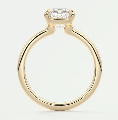Gold princess cut diamond engagement ring with a solitaire setting.