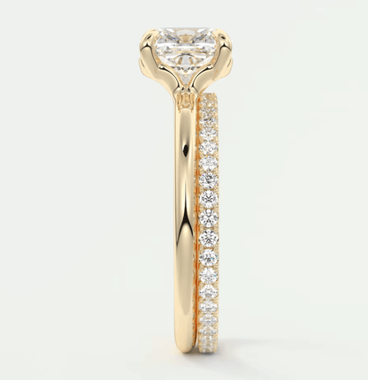 18k yellow gold engagement ring with a princess cut diamond and pave set side stones.