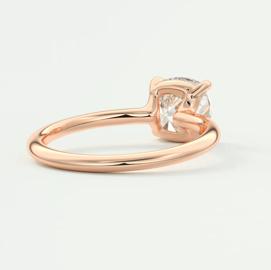 Rose gold engagement ring with a cushion-cut diamond.
