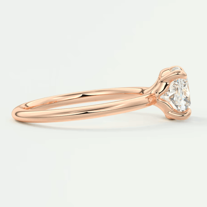 18-karat rose gold engagement ring with a round diamond.