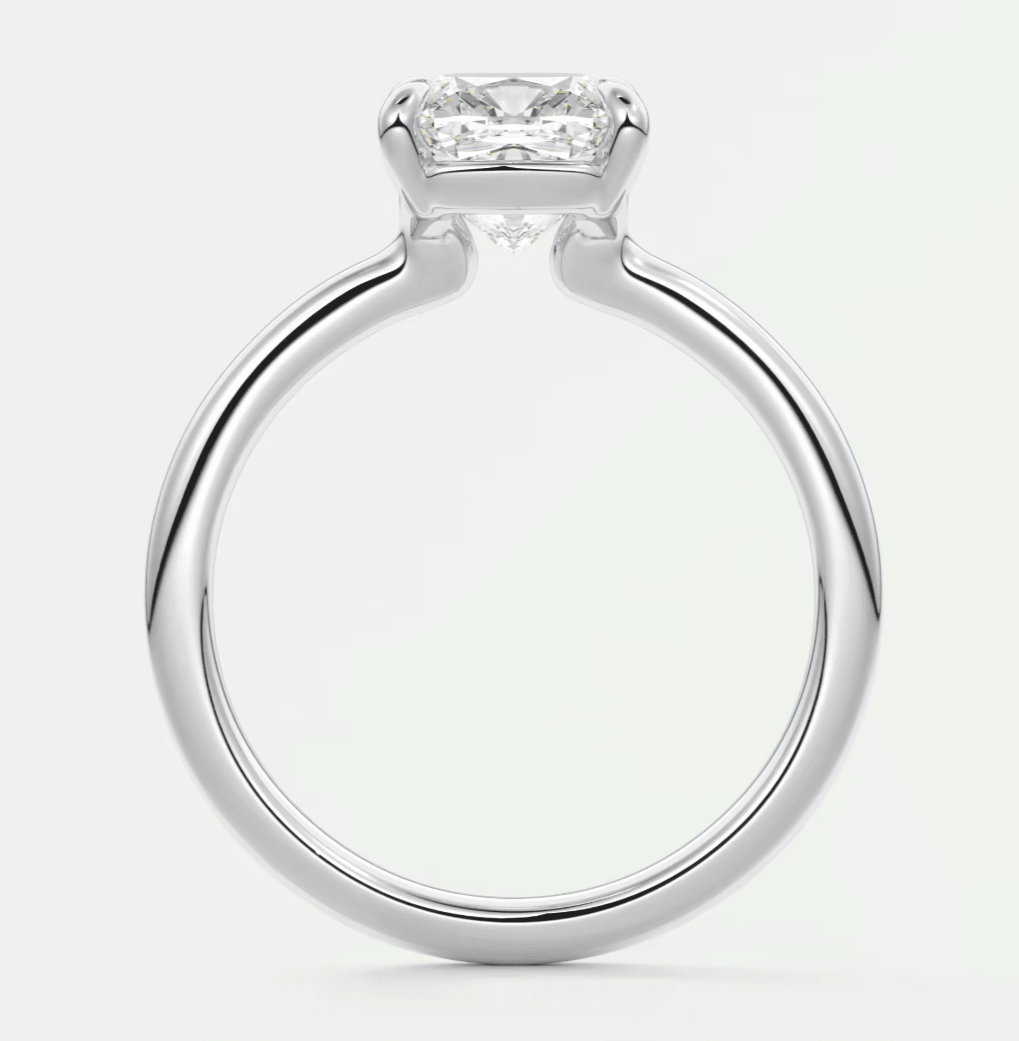 Silver diamond engagement ring with a princess cut center stone and four prongs.