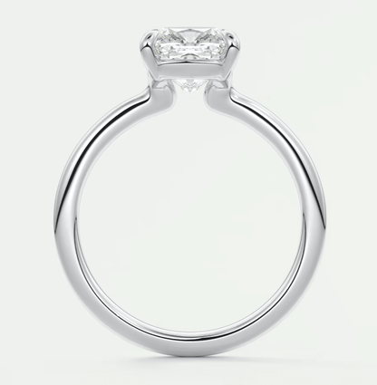 Silver diamond engagement ring with a princess cut center stone and four prongs.