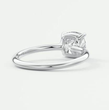White gold solitaire diamond engagement ring with a cushion-cut gemstone.
