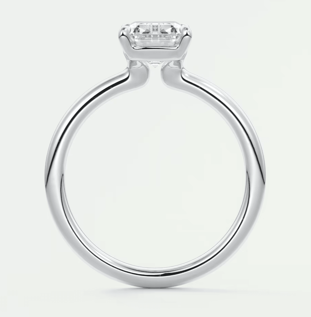 18-karat white gold engagement ring with a princess-cut diamond.