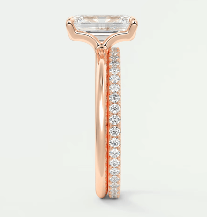 18-karat rose gold engagement ring with a rectangular diamond center and pavé diamonds on the band.