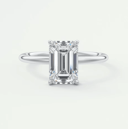 18k white gold emerald cut diamond engagement ring with a solitaire design.