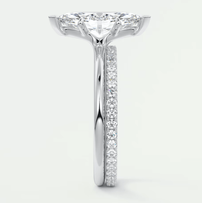 18k white gold diamond engagement ring with a princess cut center stone and pave set diamonds on the band.