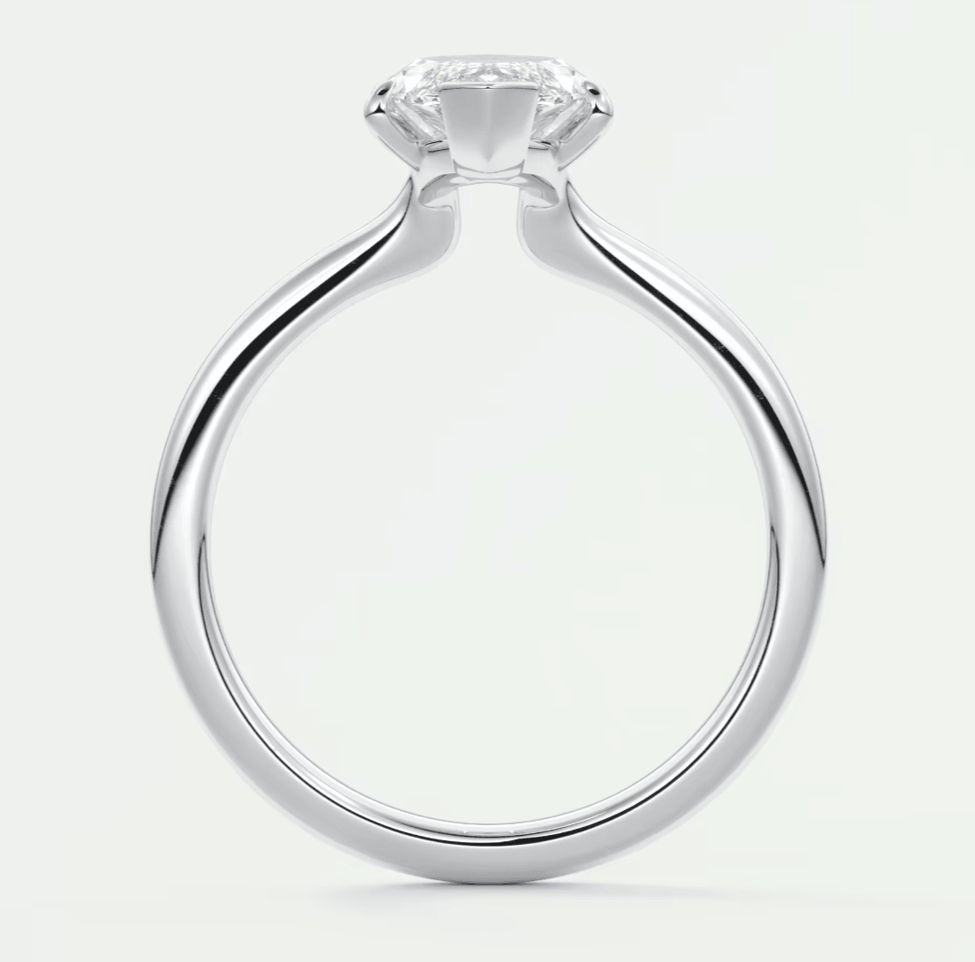 White gold solitaire diamond engagement ring with a cushion-cut center stone.