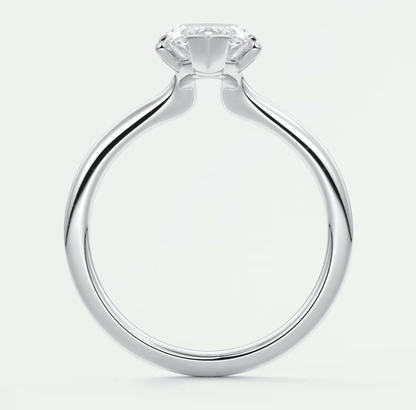 White gold solitaire diamond engagement ring with a cushion-cut center stone.