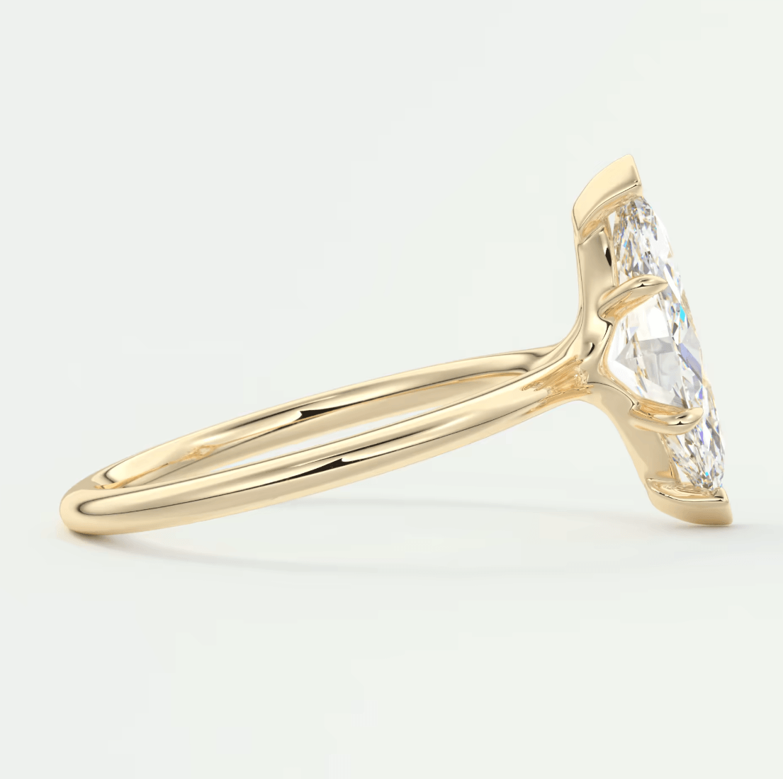 18k yellow gold engagement ring with a marquise-cut diamond.
