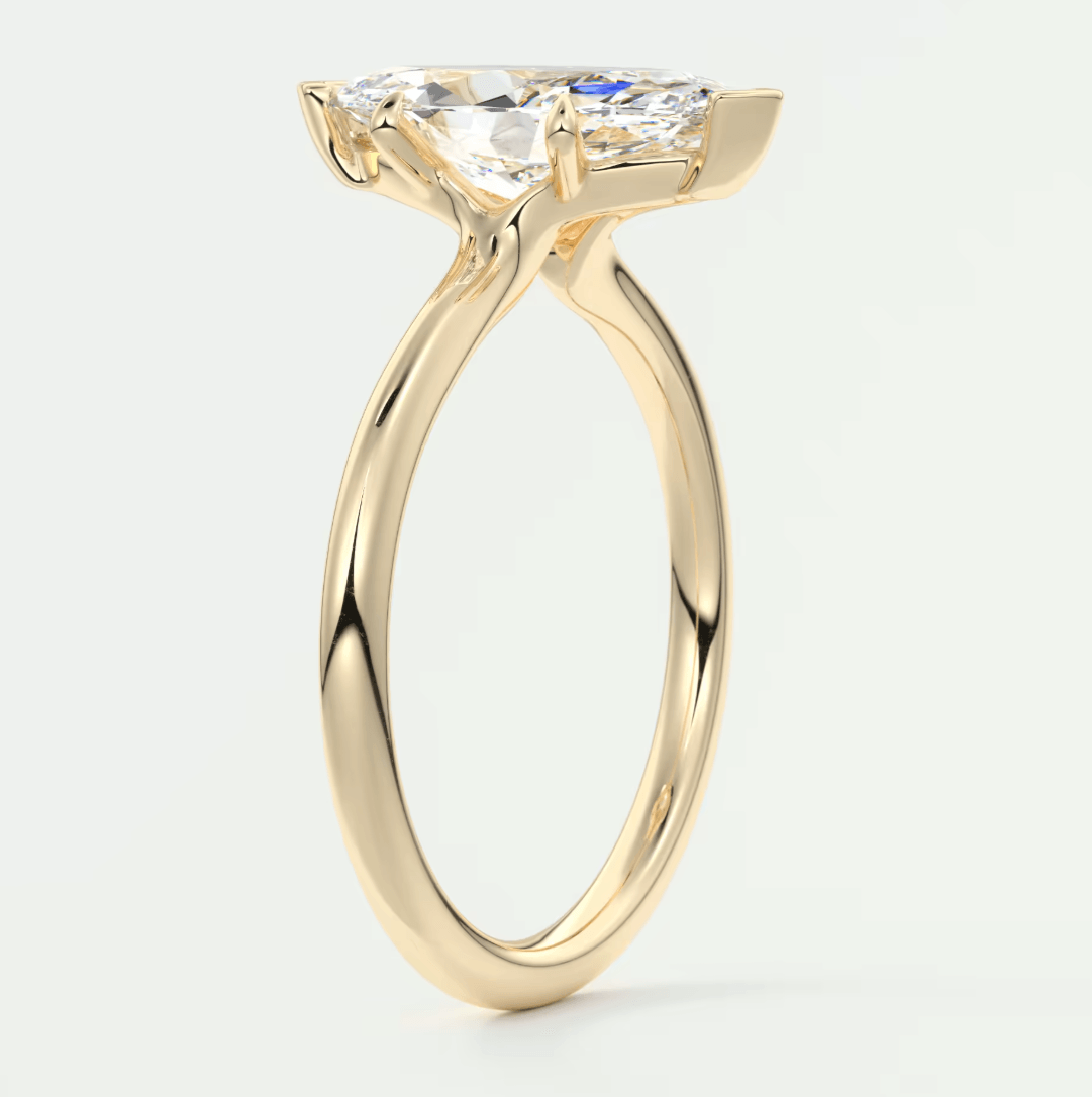 18-karat yellow gold engagement ring with a marquise-cut diamond.