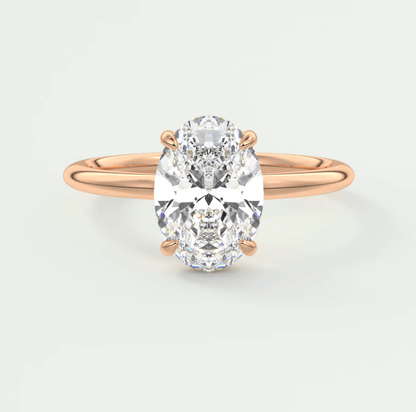 18-karat rose gold engagement ring with a cushion-cut diamond.