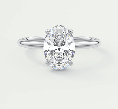 18-karat white gold oval diamond engagement ring with a solitaire setting.