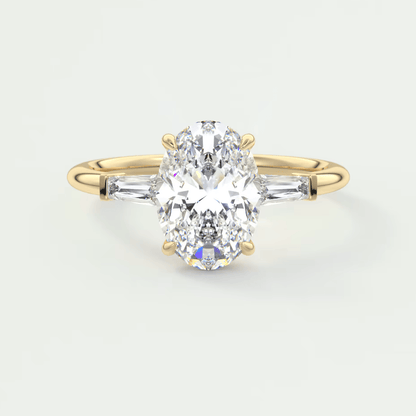 18k yellow gold engagement ring with a pear-shaped diamond and baguette diamonds on the band.