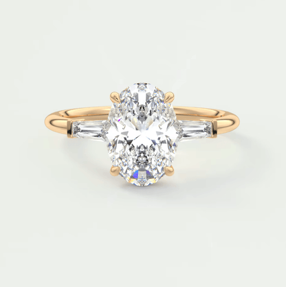 18k gold diamond engagement ring with a marquise-cut center stone and baguette side stones.