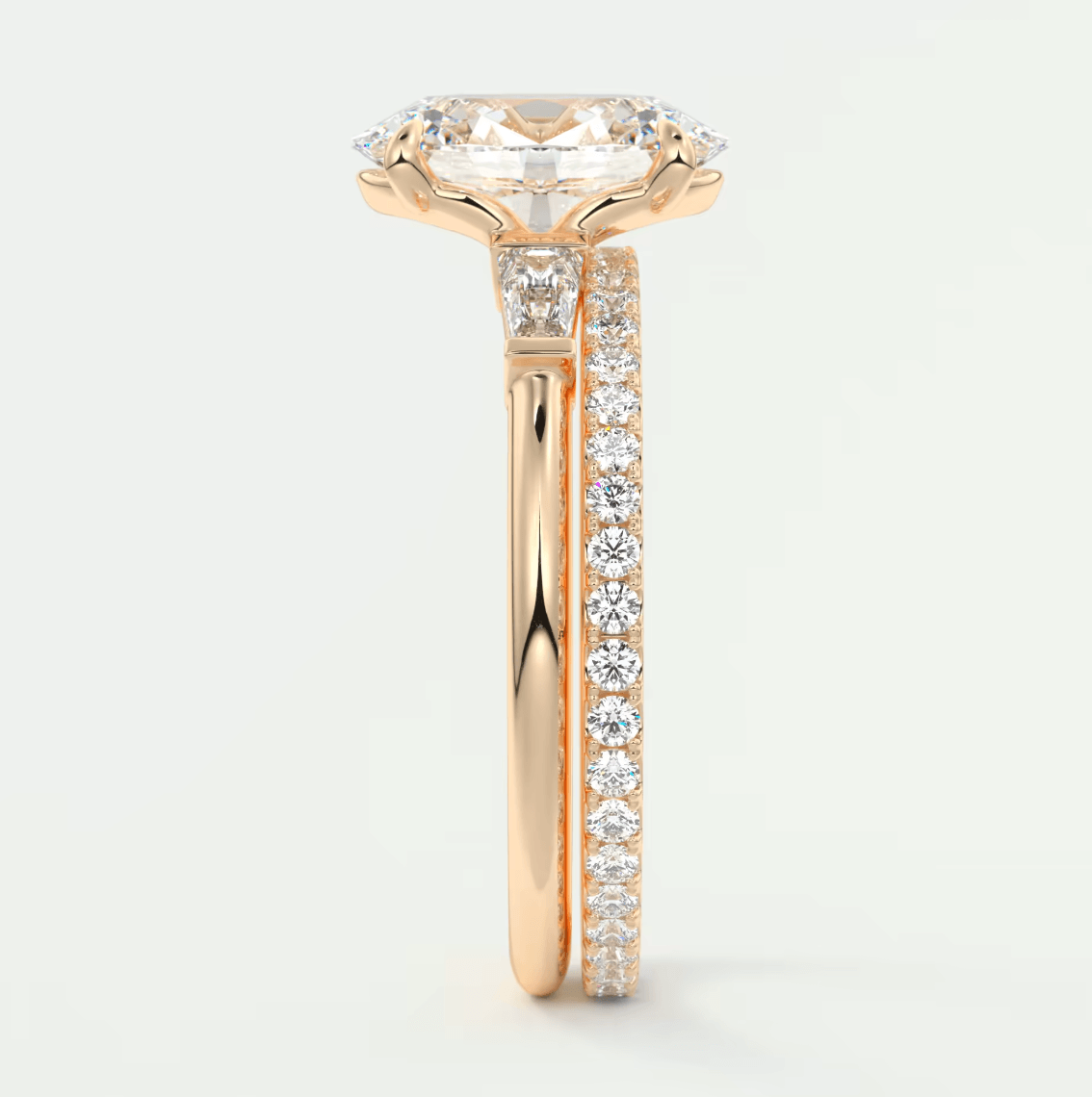 18k rose gold engagement ring with a cushion-cut diamond and pavé set diamonds on the band.