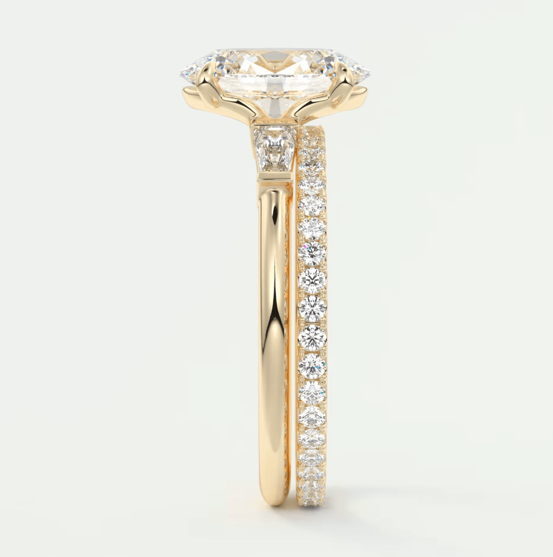 18k yellow gold engagement ring with a cushion-cut diamond center stone and pavé set diamonds on the band.