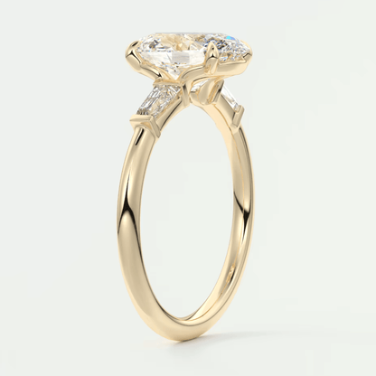 18-karat yellow gold engagement ring with a marquise-cut diamond and two side diamonds, featuring an intricate floral design.