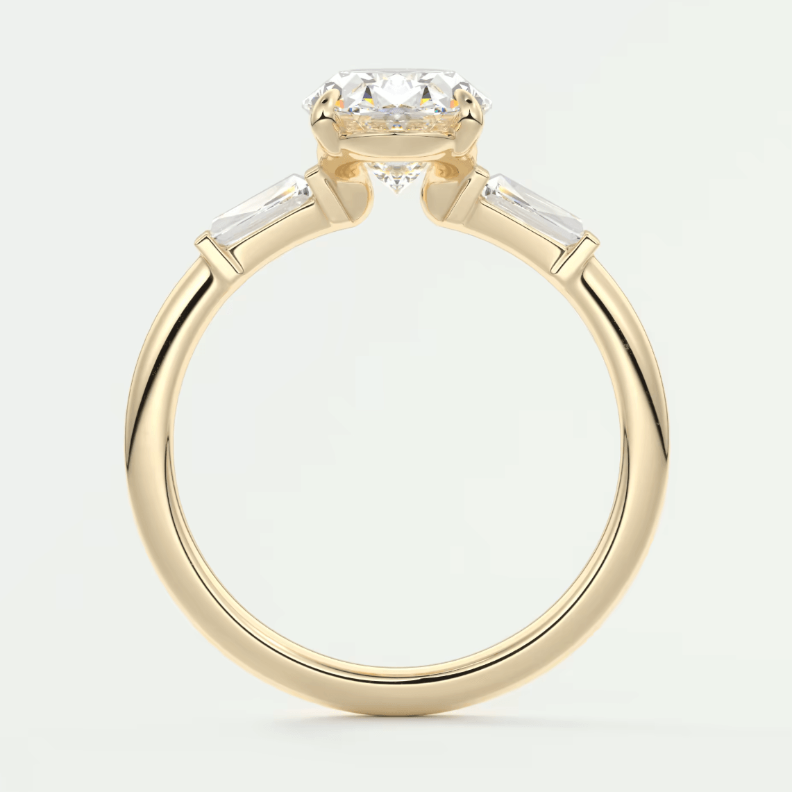 18k yellow gold engagement ring with a round diamond center stone and baguette side stones.