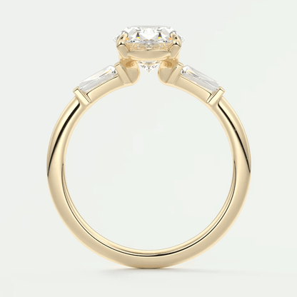 18k yellow gold engagement ring with a round diamond center stone and baguette side stones.