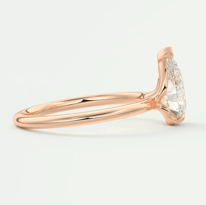 Rose gold diamond engagement ring with a halo design and pave set diamonds on the band.