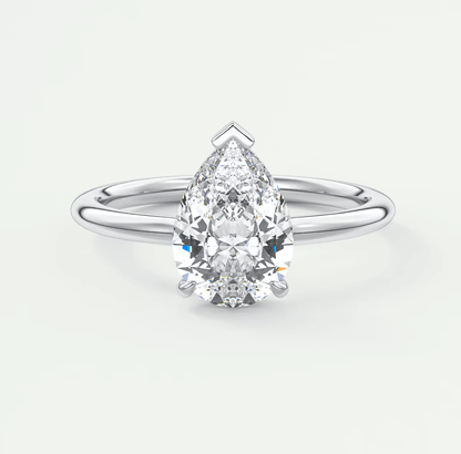 Pear-shaped diamond engagement ring with white gold band and prong setting.