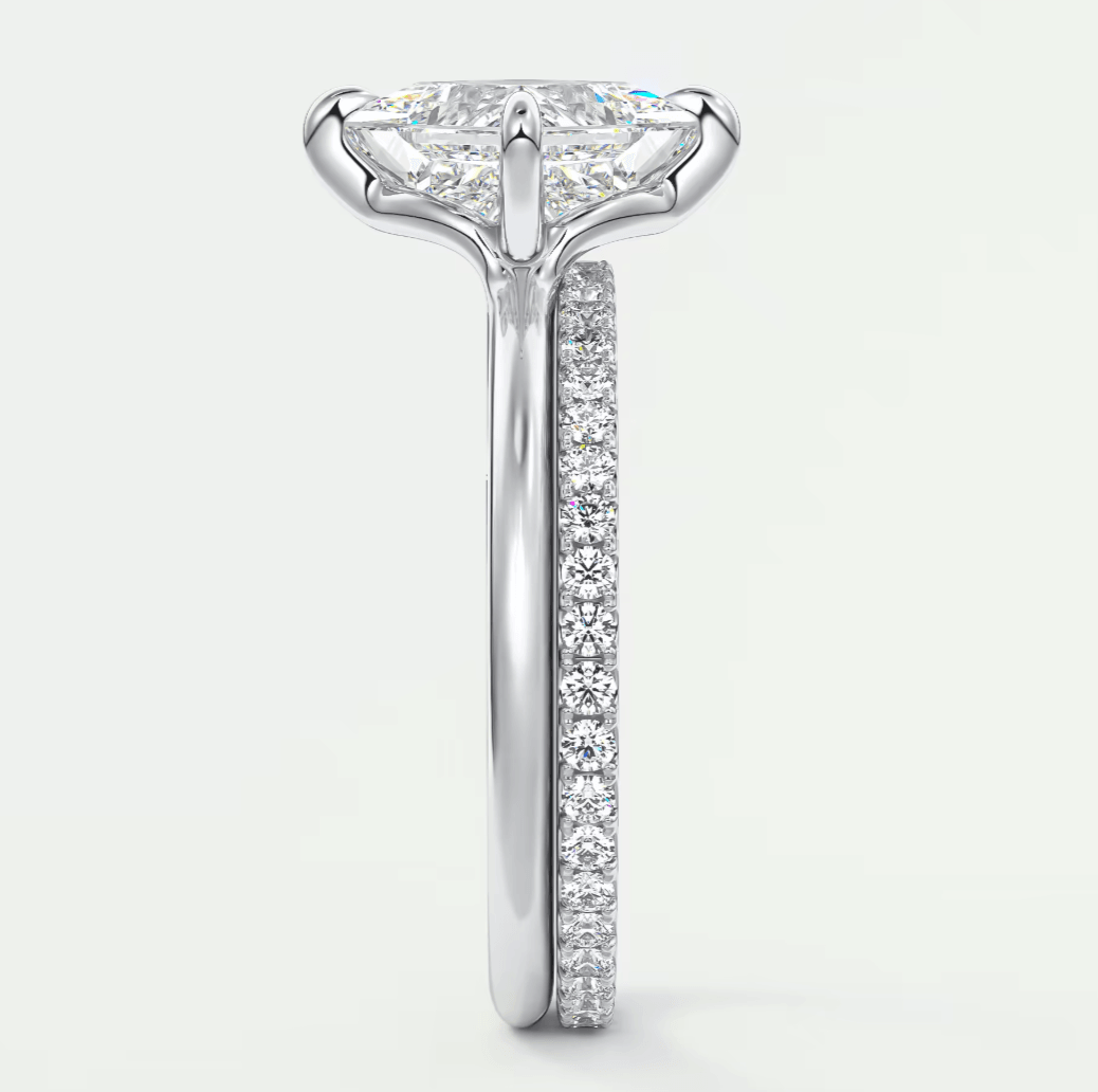 18k white gold diamond engagement ring with a princess cut center stone and pave set diamonds on the band.