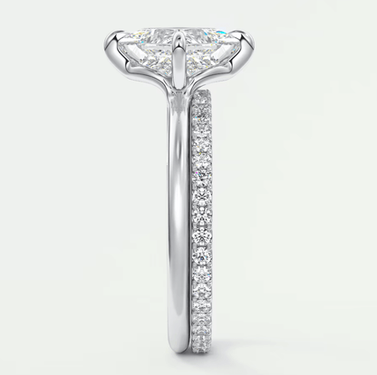 18k white gold diamond engagement ring with a princess cut center stone and pave set diamonds on the band.