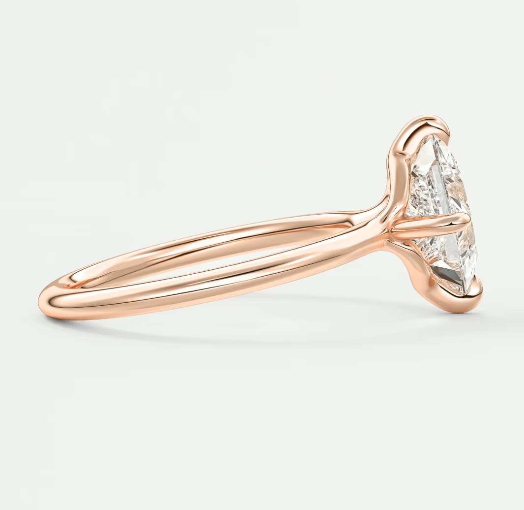 18k rose gold engagement ring with marquise diamond.