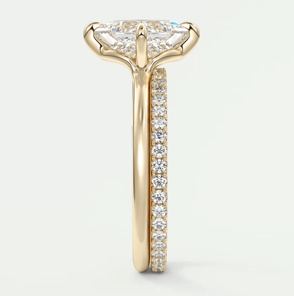 18k yellow gold engagement ring with a marquise-cut diamond and pave-set diamonds on the band.
