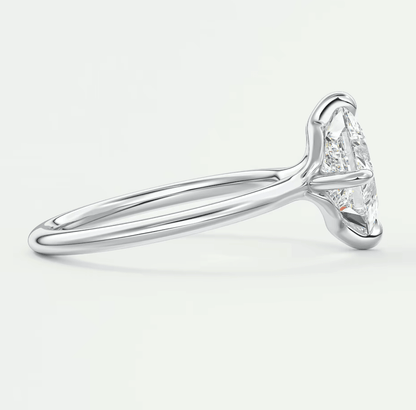 18k white gold solitaire diamond engagement ring with a marquise-cut stone.