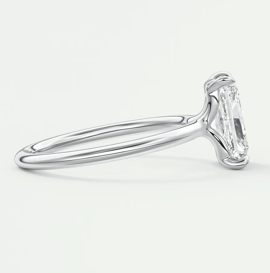 18-karat white gold engagement ring with a marquise-cut diamond.