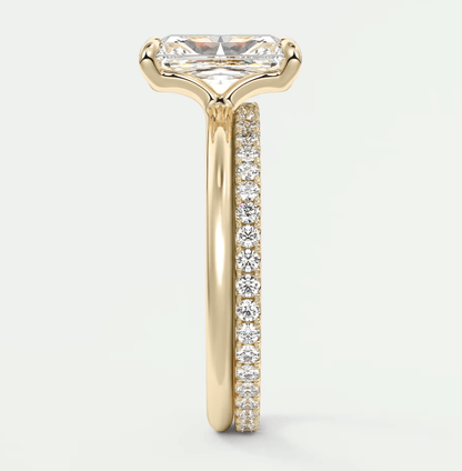 18k yellow gold engagement ring with a princess cut diamond and pave set diamonds on the band.