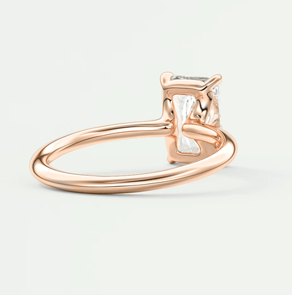 Rose gold diamond engagement ring with a square-cut gemstone and four-prong setting.