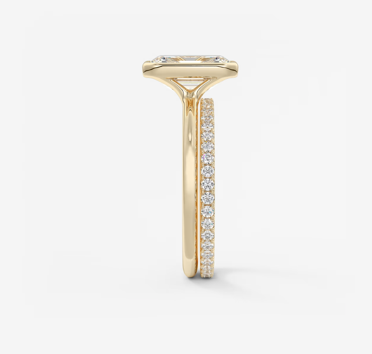 Gold ring with diamond accents on a white background