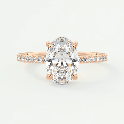 18k rose gold diamond engagement ring with an oval-cut center stone and pave-set diamonds on the band.