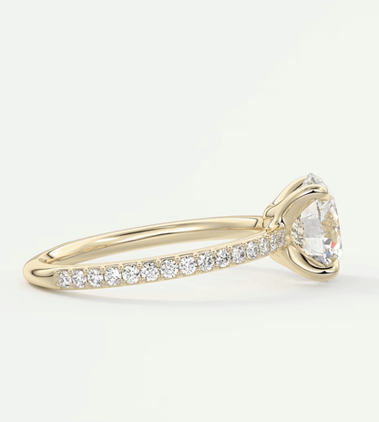 18k yellow gold diamond engagement ring with a marquise-cut center stone and pave-set diamonds on the band.