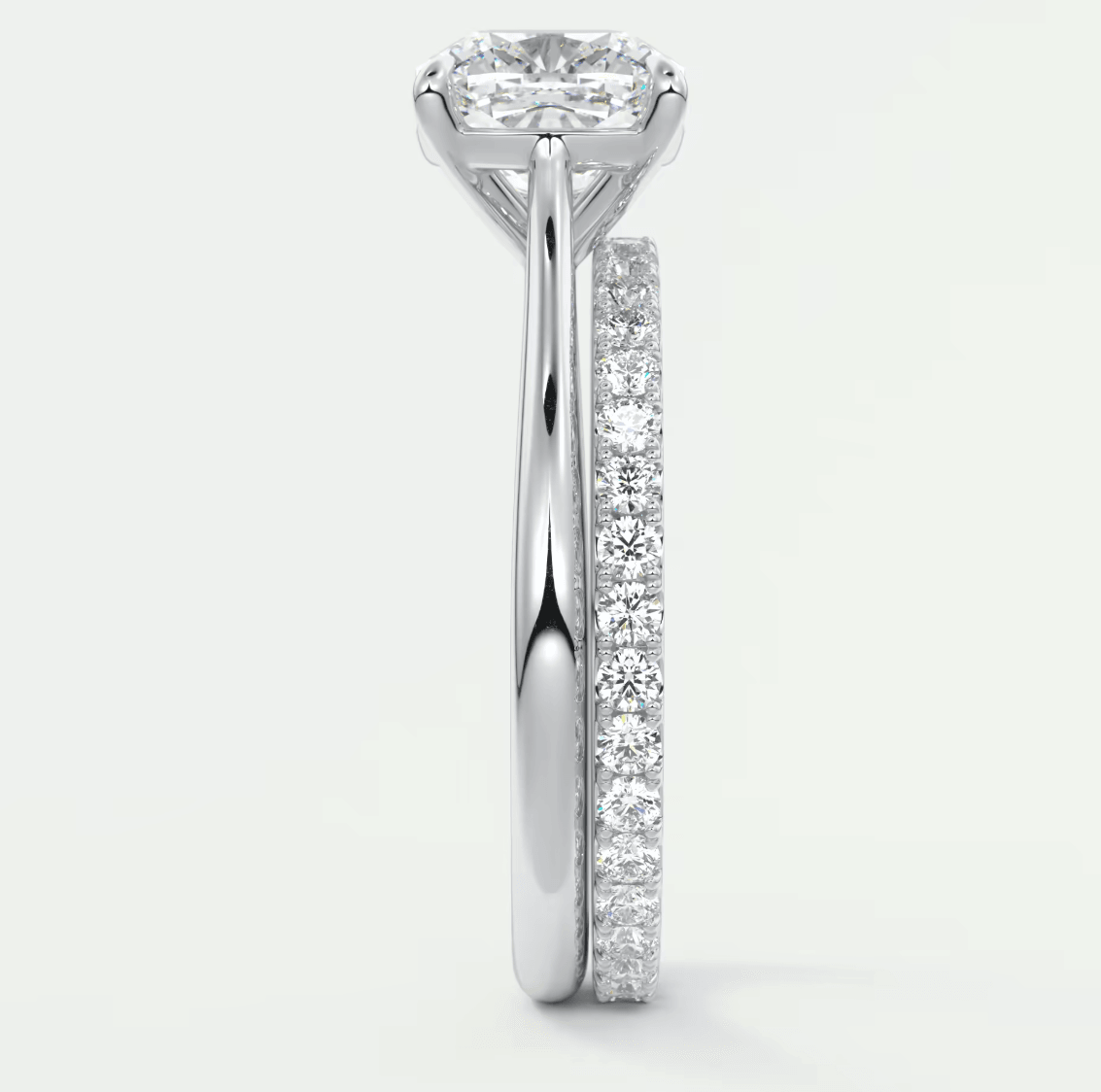 18-karat white gold engagement ring with a princess-cut diamond center stone and pavé set diamonds on the band.