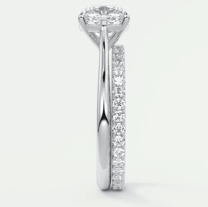 18-karat white gold engagement ring with a princess-cut diamond center stone and pavé set diamonds on the band.