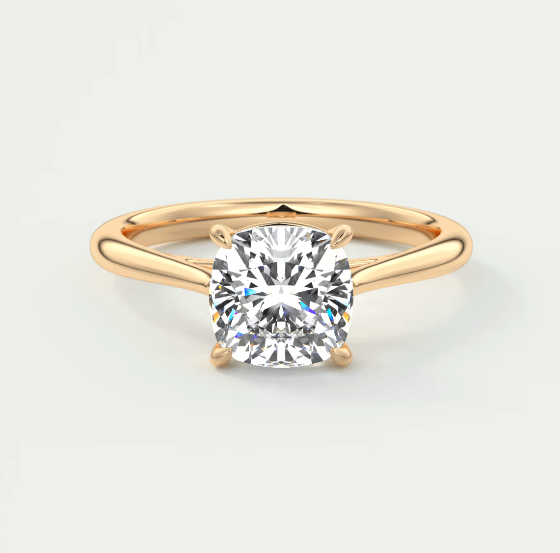 18-karat gold engagement ring with a cushion-cut diamond.