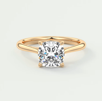 18-karat gold engagement ring with a cushion-cut diamond.