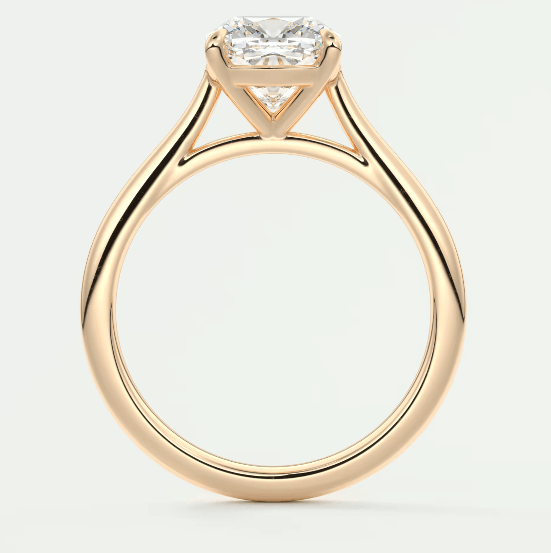 18-karat yellow gold engagement ring with a cushion-cut diamond.