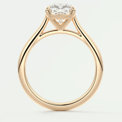 18-karat yellow gold engagement ring with a cushion-cut diamond.