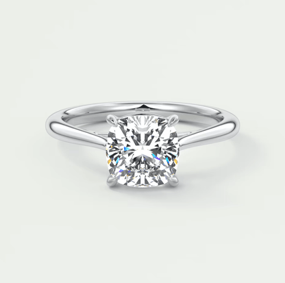 Cushion-cut diamond engagement ring with a white gold band.
