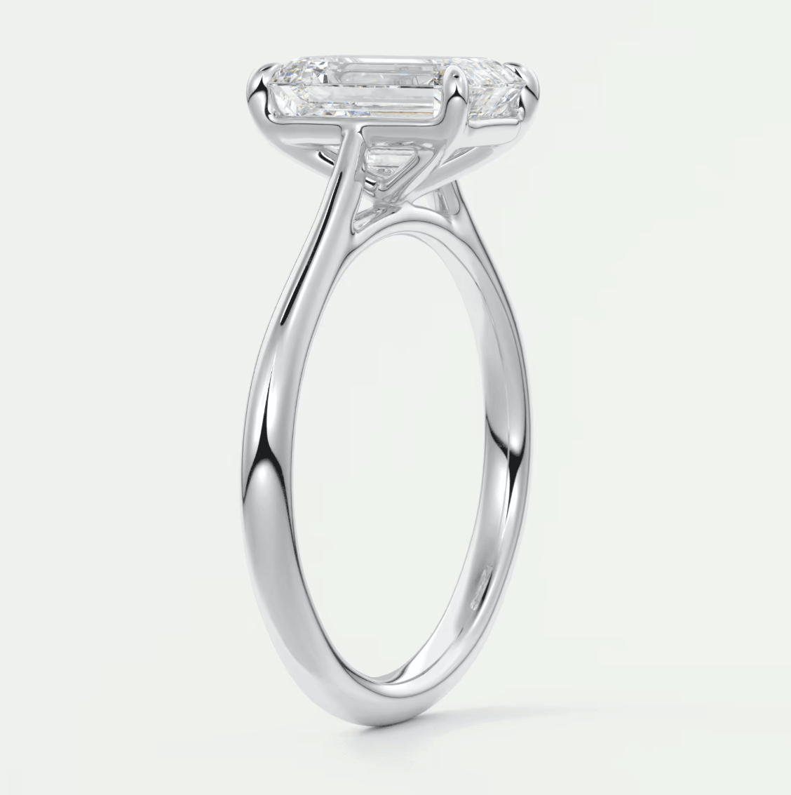 18-karat white gold engagement ring with an emerald-cut diamond.