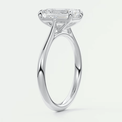 18-karat white gold engagement ring with an emerald-cut diamond.