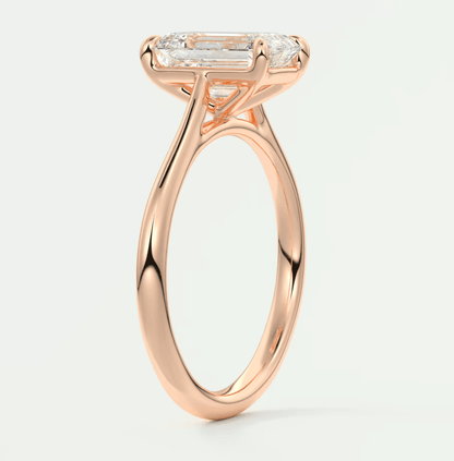 18k rose gold engagement ring with a marquise-cut diamond.
